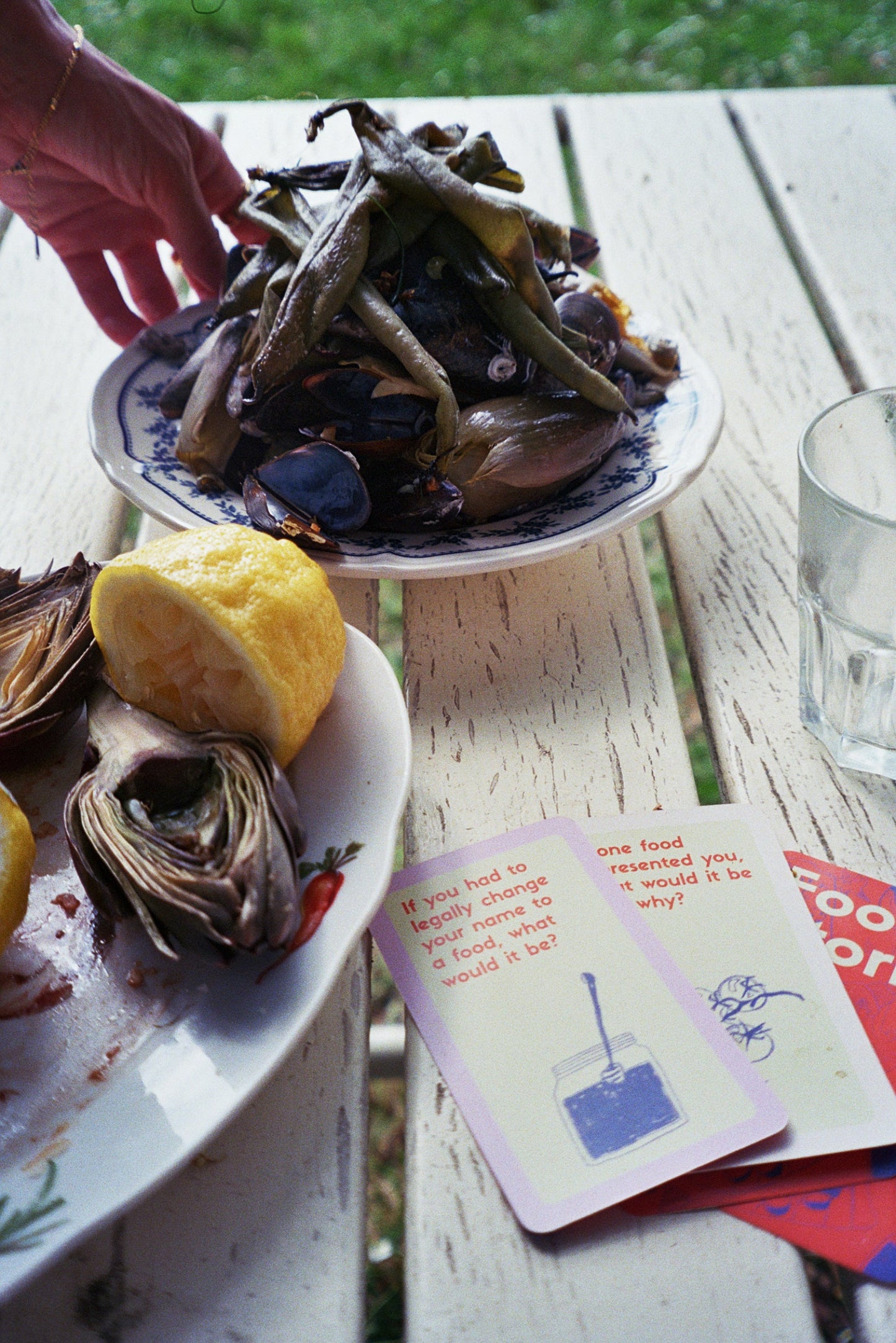 Oysters on a half shell with lemon wedges and a card on a wooden surface